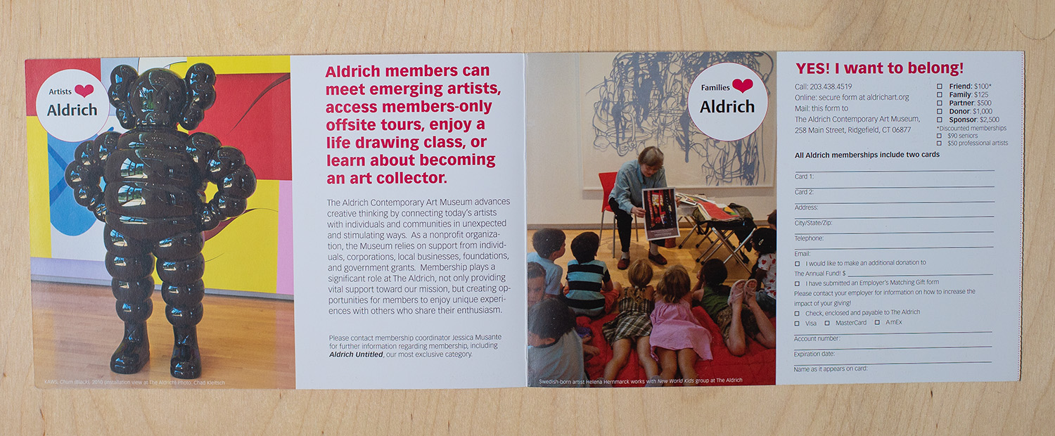 interior of membership brochure for The Aldrich Contemporary Art Museum featuring an image of a sculpture by the artist KAWS