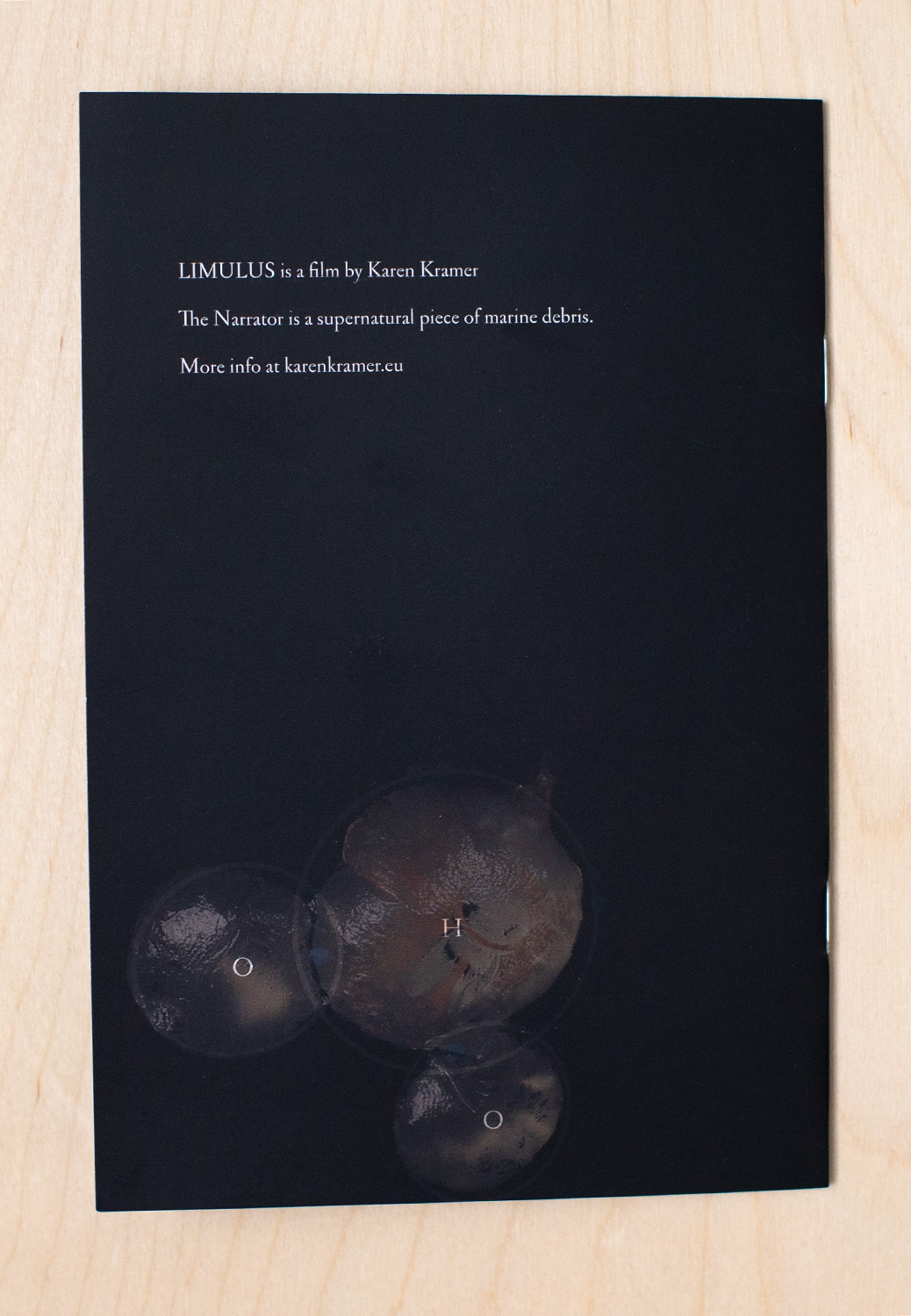 Photo of the back cover of the publication for the film LIMULUS, featuring the molecular structure of water (H2O)